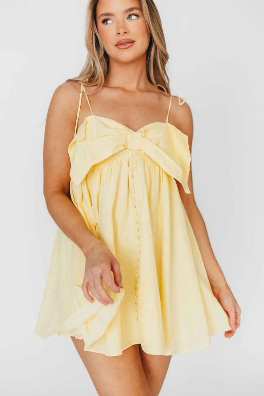 Discount Worth Collective Irelyn Babydoll Mini Dress with Bow Accent in Yellow