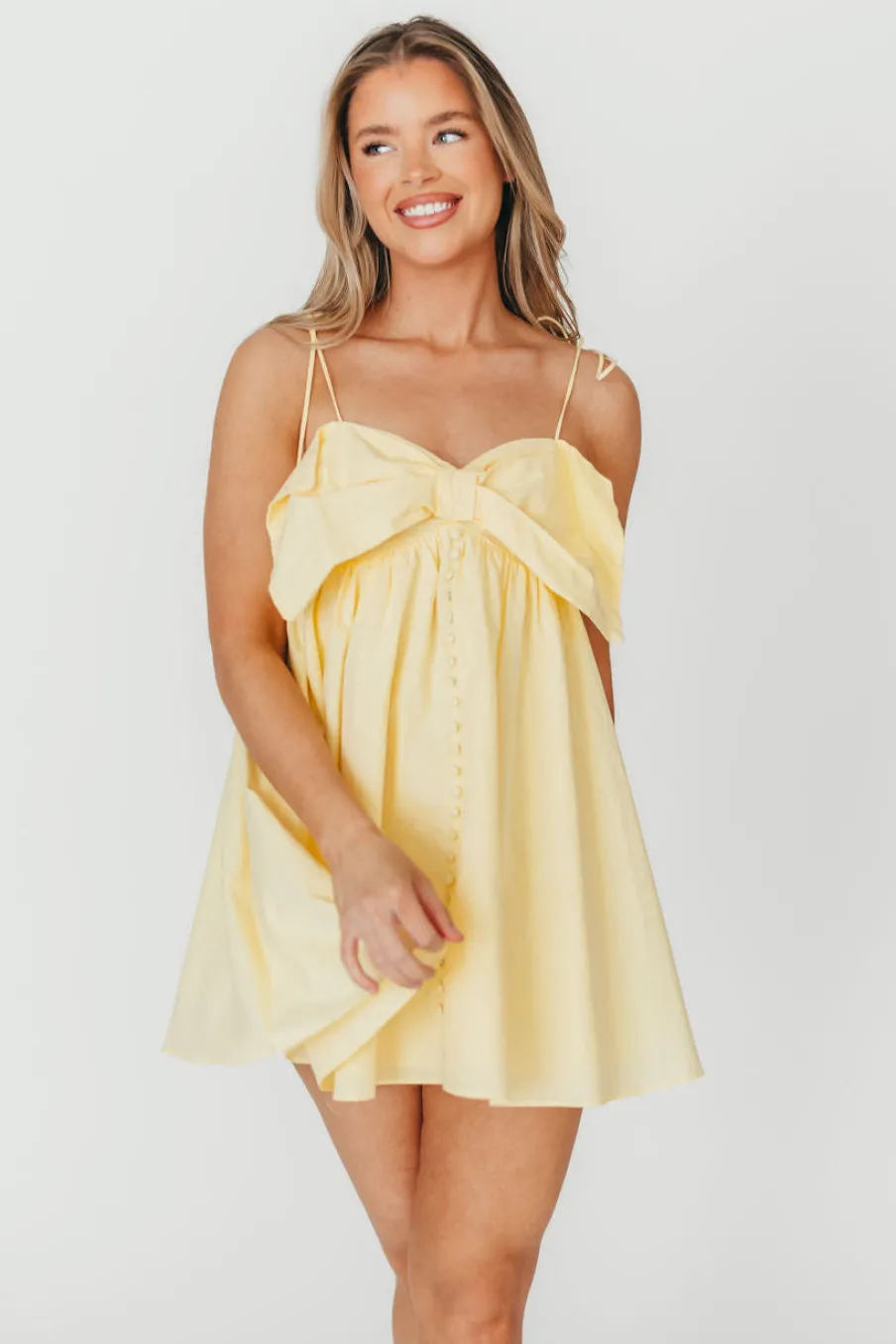 Discount Worth Collective Irelyn Babydoll Mini Dress with Bow Accent in Yellow