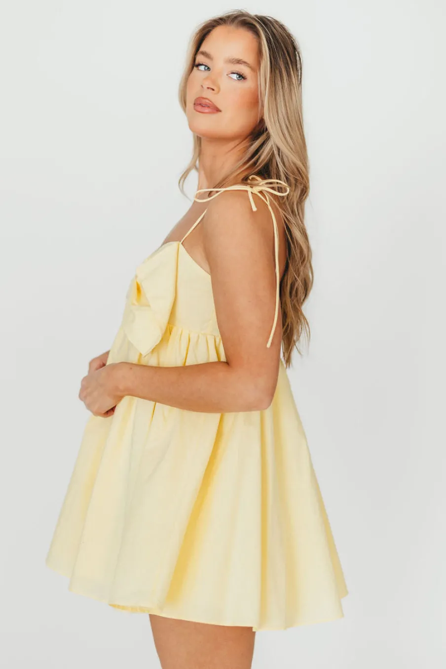 Discount Worth Collective Irelyn Babydoll Mini Dress with Bow Accent in Yellow